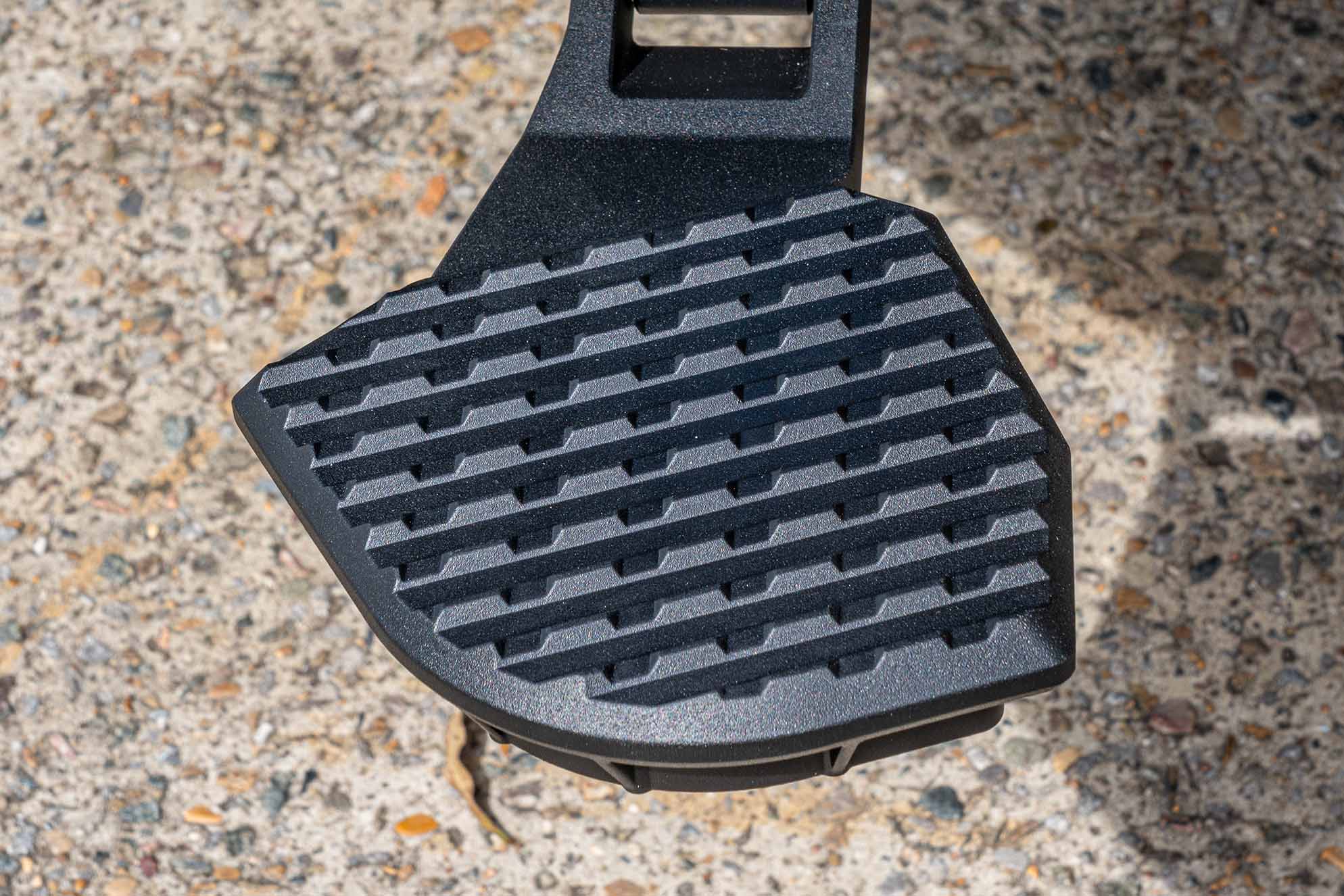 Extreme close-up of the heavy-duty, non-slip tread on the Supreme Electric Rear Step for safe utility access