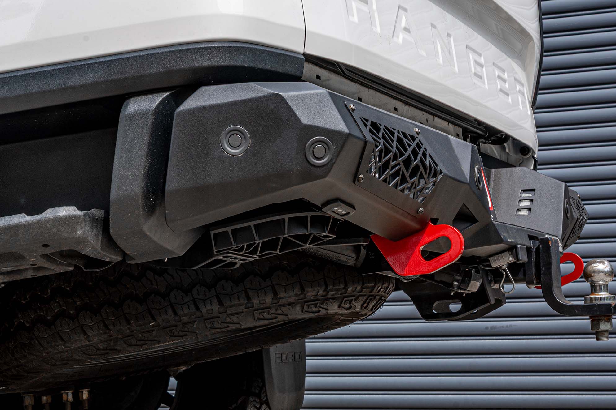 Supreme Electric Rear Step fully retracted under the bumper of the Next-Gen Ford Ranger, maintaining an OEM look.